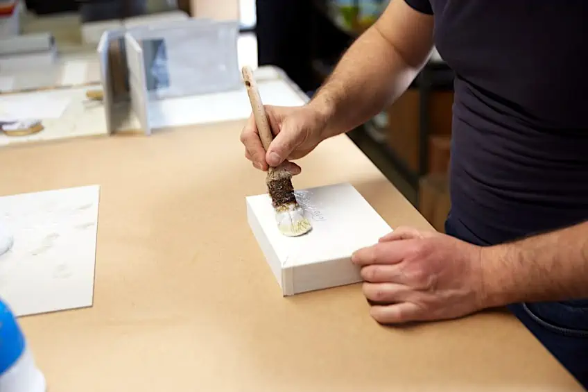 Brushing Binding Glue to Book